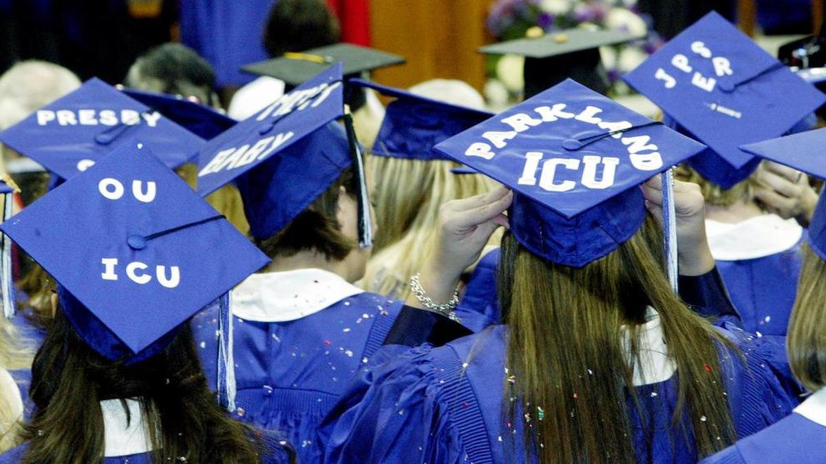 Nursing student graduates display their jobs awaiting them on top of their caps during a 2004 TCU Commencement.