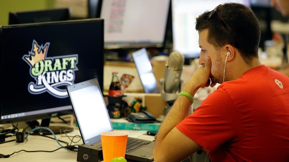 A DraftKings employee works on his computer at the company’s offices in Boston.