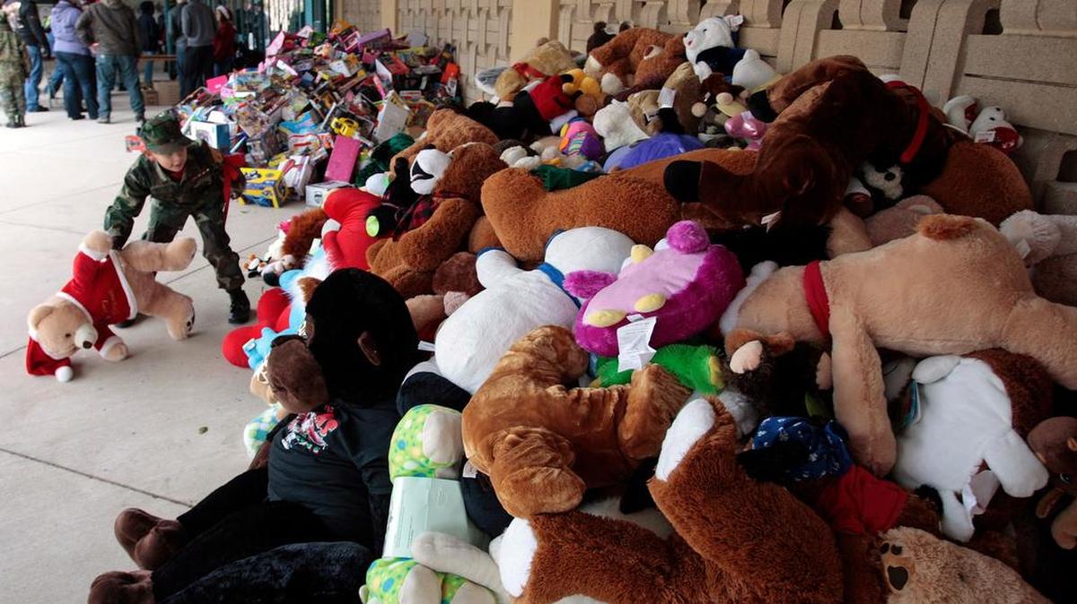 Tarrant County Young Marines Pvt Joshua Acevedo puts a stuffed bear back onto the pile in the 'toy pit' at Lone Star Park as hundreds of riders took part in the 28th Annual Big Texas Toy Run on Saturday, December 14, 2013. The Big Texas Toy Run benefits Mental Health-Mental Retardation (MHMR) of Tarrant County, Metrocare Services in Dallas County, and other children's charities in the Metroplex.