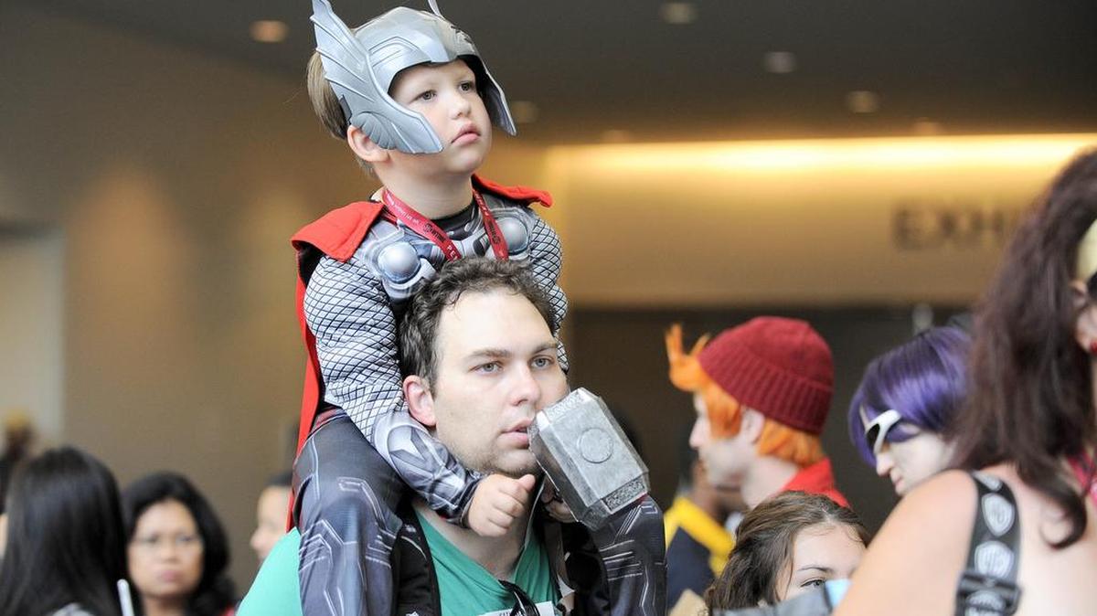 Braden Schreiter, 4, as Thor, rides on his father Justin Schreiter's back on Day 3 at the 2014 Comic-Con International Convention.