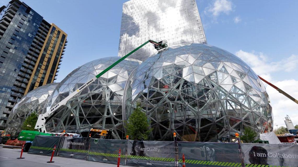 Construction on three large, glass-covered domes as part of an expansion of the Amazon.com campus in downtown Seattle in April. Amazon said that it will spend more than $5 billion to build another headquarters in North America to house as many as 50,000 employees.