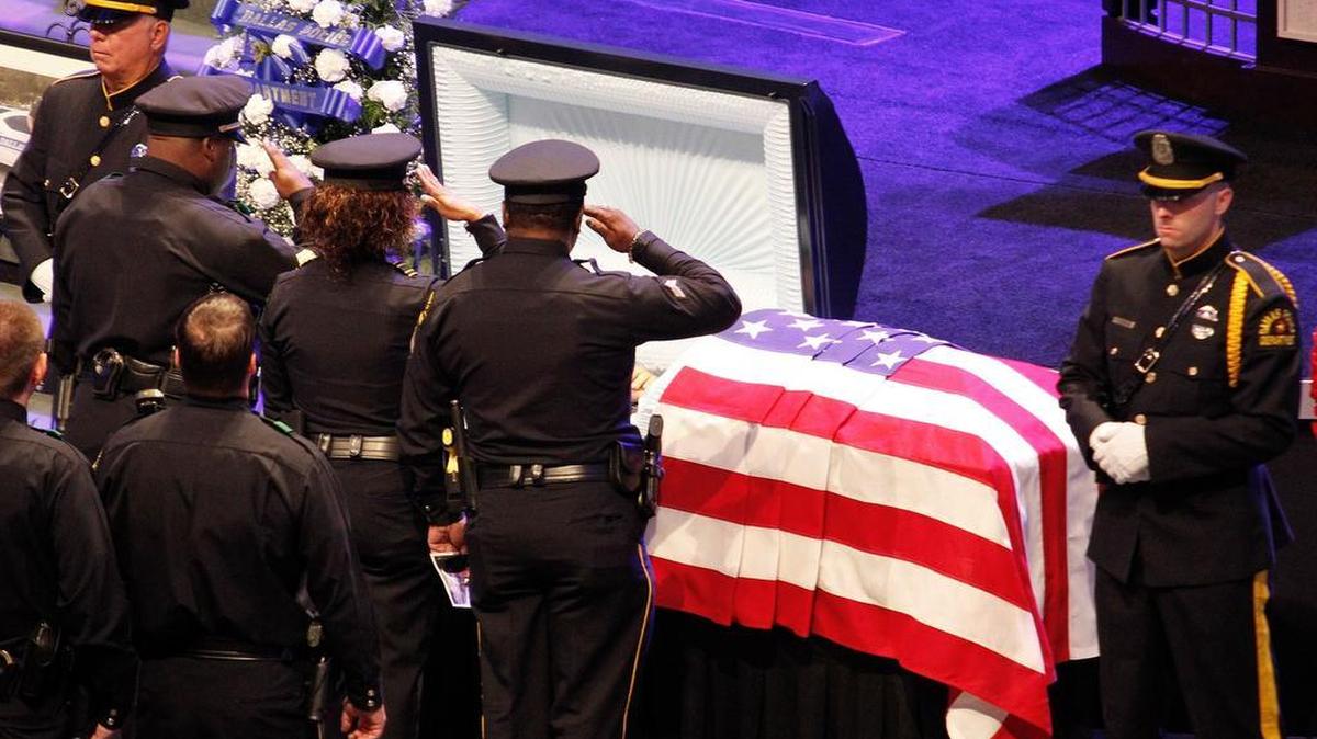 Officers salute Dallas police Sr. Cpl. Lorne Ahrens, killed in last year’s shooting.