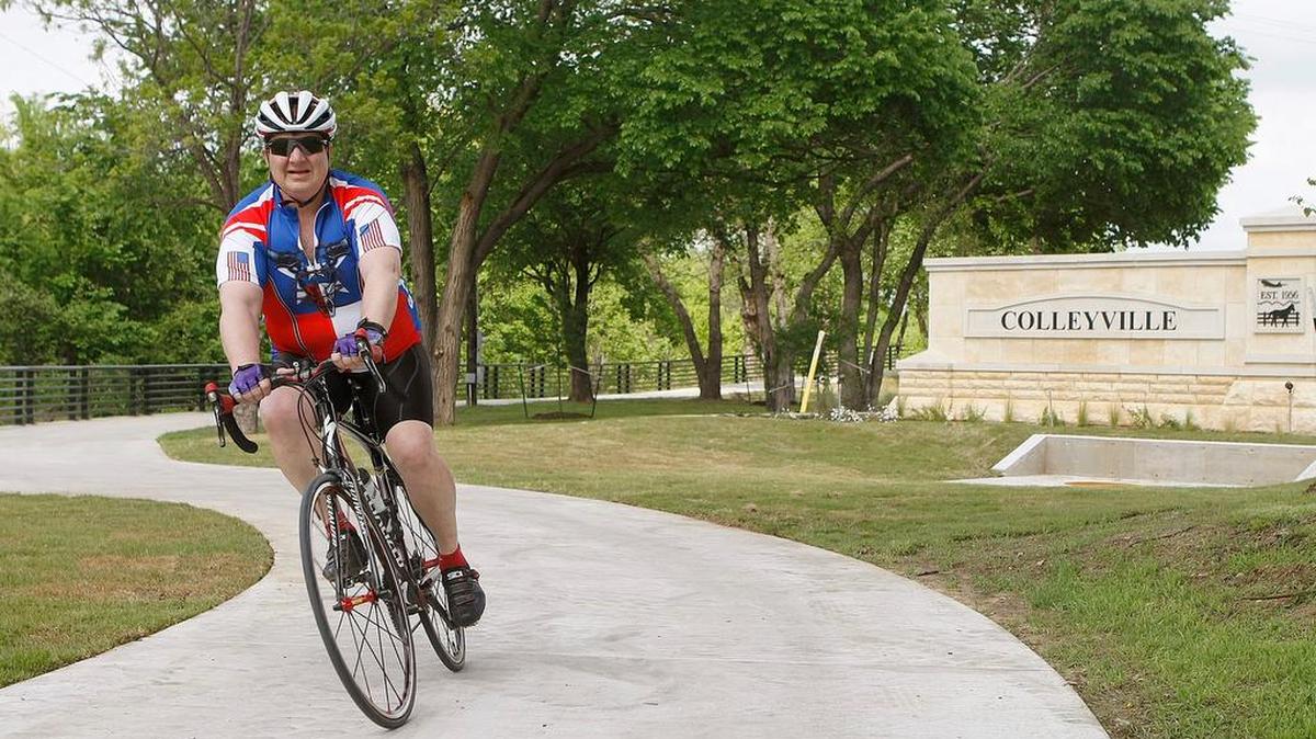 A bicycle rider enjoys the Cottonbelt Trail in Colleyville.