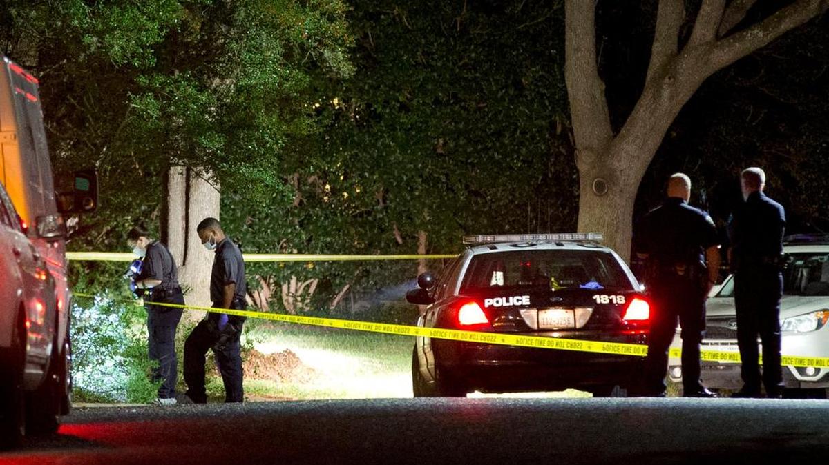 Authorities investigate the scene where District Judge Julie Kocurek was shot Nov. 6 in the driveway of her home.