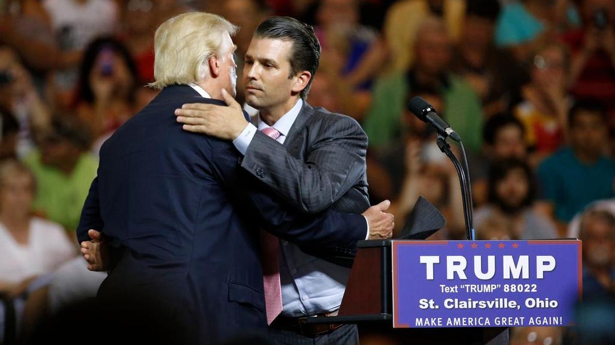 Republican presidential candidate Donald Trump, left, hugs his son Donald Trump Jr. during a rally in 2016.