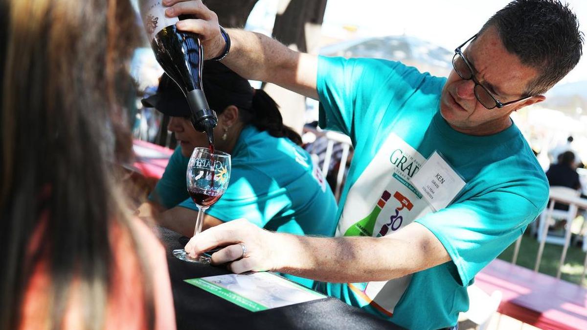Ken Davis pours samples of wine at the 30th Annual GrapeFest on Sept. 17 in Grapevine. The city’s mayor fears large liquor stores would harm the city’s wine-focused image and local merchants.
