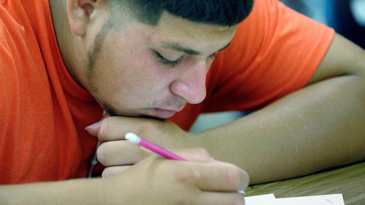 Juan Alvarez working in his English II class during summer school at Dunbar High School in Fort Worth.