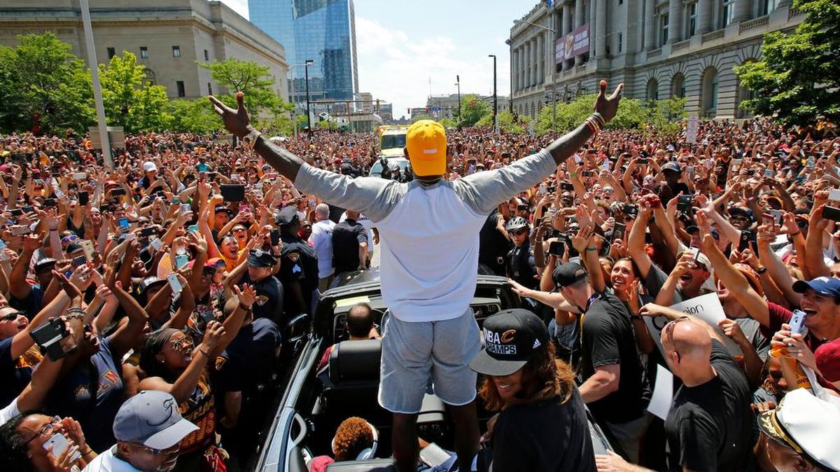 Cleveland Cavaliers’ LeBron James, center, greets crowd during a parade celebrating the basketball team’s NBA championship.