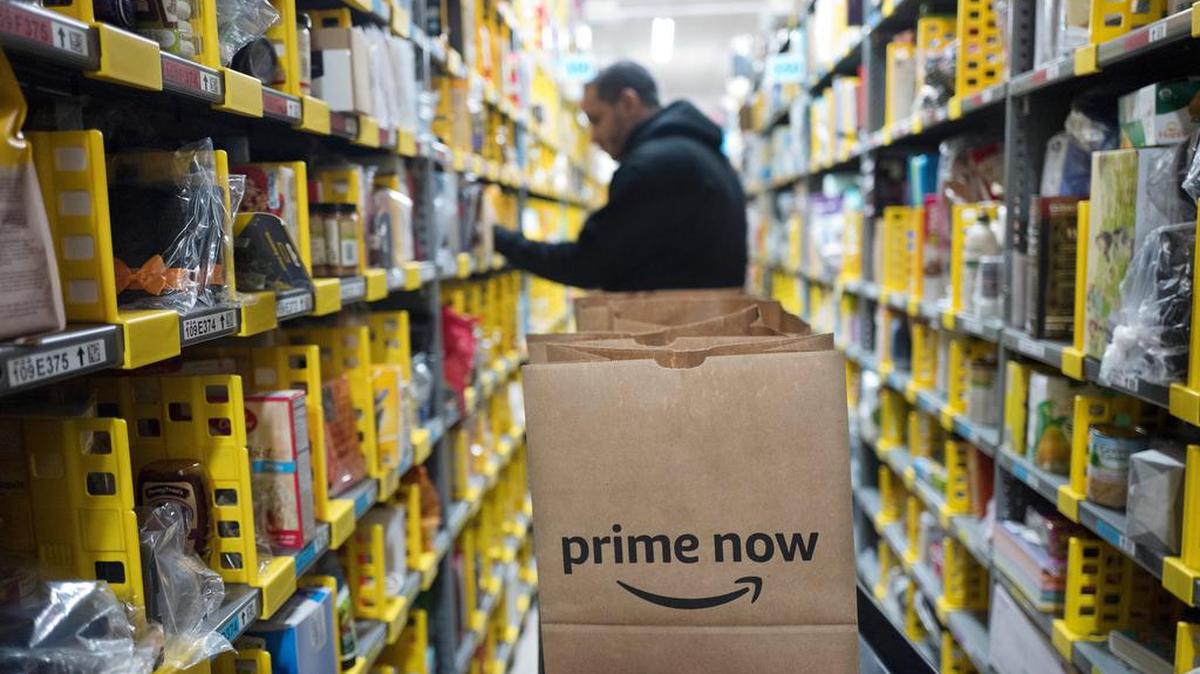 A clerk reaches to a shelf to pick an item for a customer order at the Amazon Prime warehouse, in New York. Amazon announced Thursday, Jan. 18, 2018, that it has narrowed down its potential site for a second headquarters in North America to 20 metropolitan areas, mainly on the East Coast.