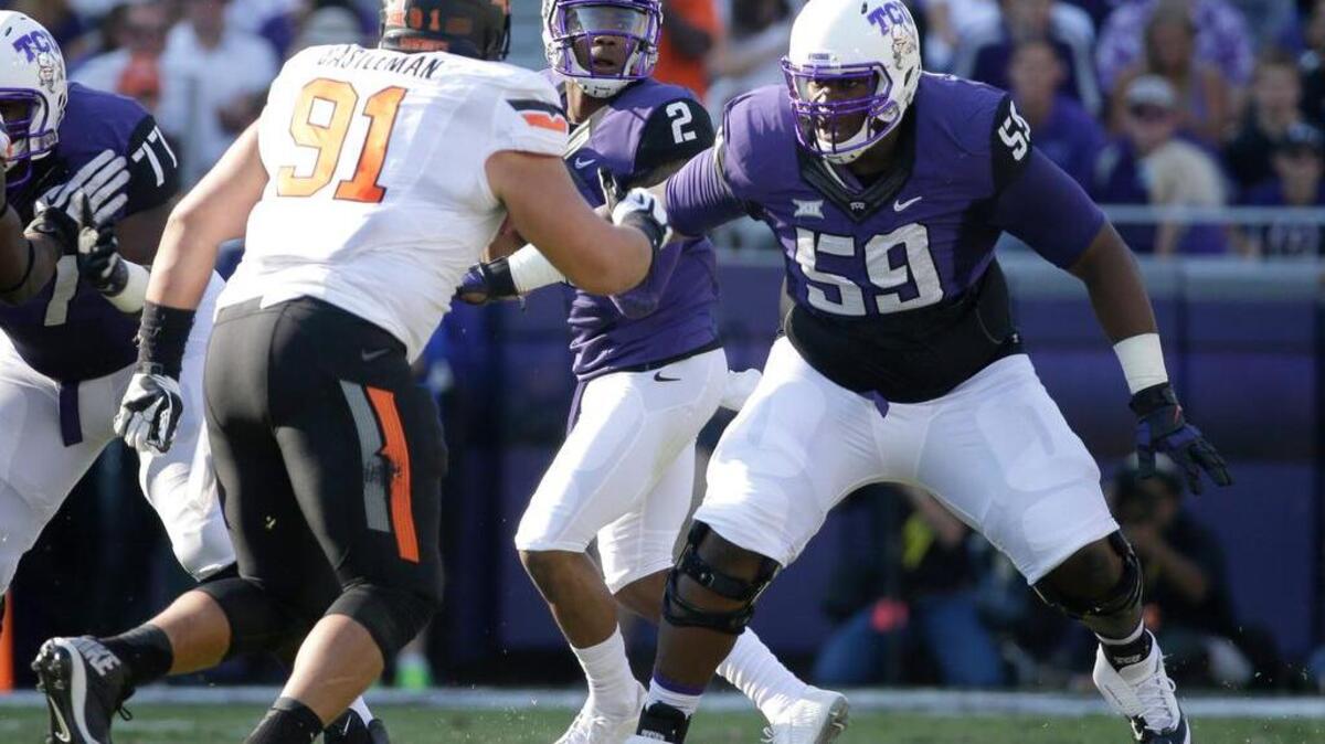 
TCU offensive tackle Tayo Fabuluje (59) defends against a rush by Oklahoma State defensive tackle James Castleman (91) during a game last October in Fort Worth. 
