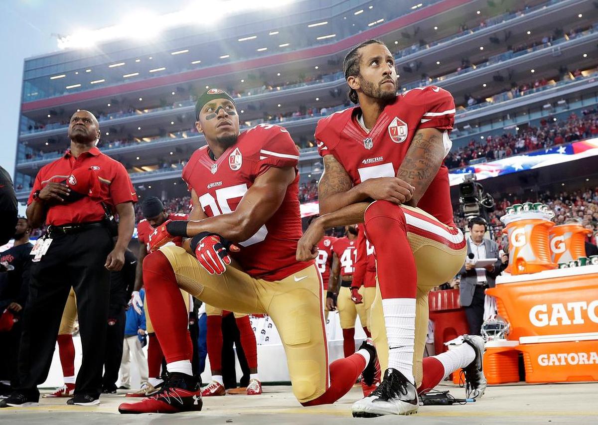 Former San Francisco 49ers quarterback Colin Kaepernick kneels during the national anthem in 2016.
