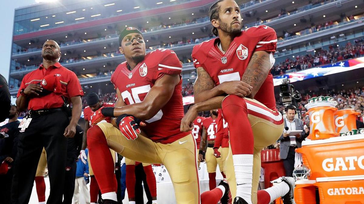 Former San Francisco 49ers quarterback Colin Kaepernick kneels during the national anthem in 2016.