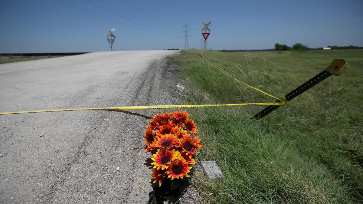 Flowers and a New Testament lay near crime scene tape at the scene of Saturday's hot air balloon crash near Lockhart, Texas, Monday, Aug. 1, 2016. Sixteen people were killed in the crash.