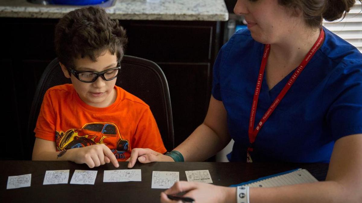 Jacob Casablanca works with speech therapist Elizabeth Price at his home in Hurst in 2015.