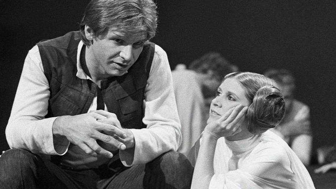 Harrison Ford talks with Carrie Fisher in 1978 during a break in the filming of the CBS-TV special “The Star Wars Holiday” in Los Angeles.