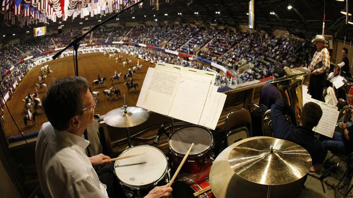 Former director Jack Cobb (far right) leads the 21-piece ensemble during the start of the nightly 2008 Fort Worth Stock Show and Rodeo performance at Will Rogers Coliseum in Fort Worth. The band is squeezed into a tiny stage in the rafters of the old building.