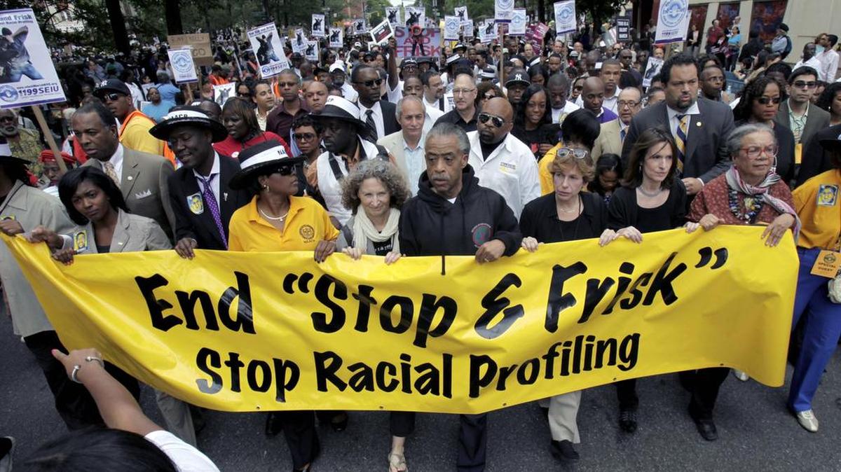 In this 2012 photograph, the Rev. Al Sharpton, center, walks with demonstrators during a silent march to end the “stop and frisk” program in New York.