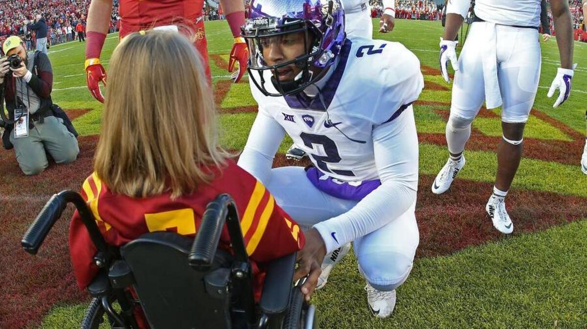 The photo that has gone ’round the world: TCU quarterback Trevone Boykin and 7-year-old Abby Faber.