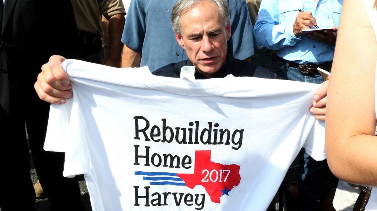 George Strait, left, and Texas Gov. Greg Abbott wave to the crowd in Rockport, Texas, Thursday, Sept. 21, 2017 during a visit with individuals affected by Hurricane Harvey.