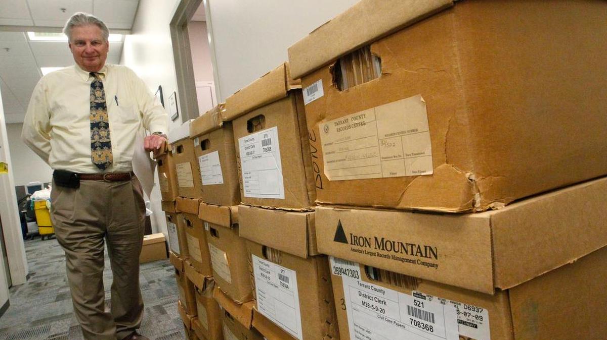 Tarrant County District Clerk Tom Wilder stands by boxes of records in 2015.