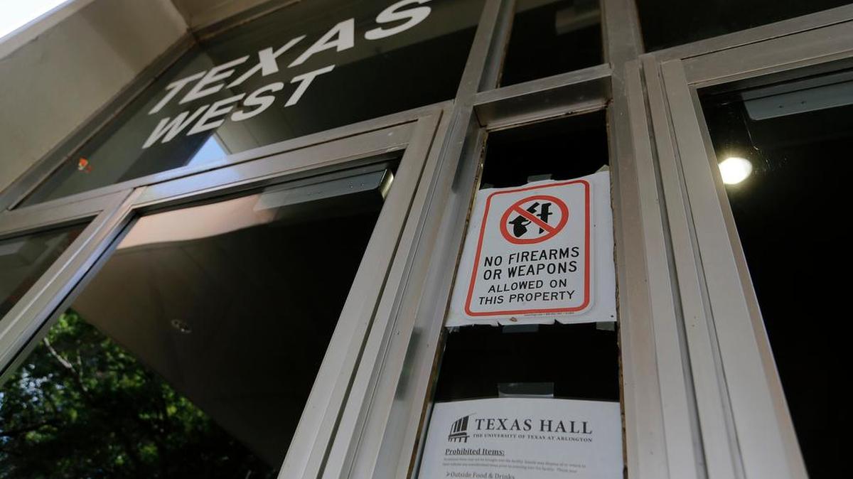 A sign prohibits weapons in Texas Hall as carrying firearms on the University of Texas at Arlington campus is not allowed in certain buildings.