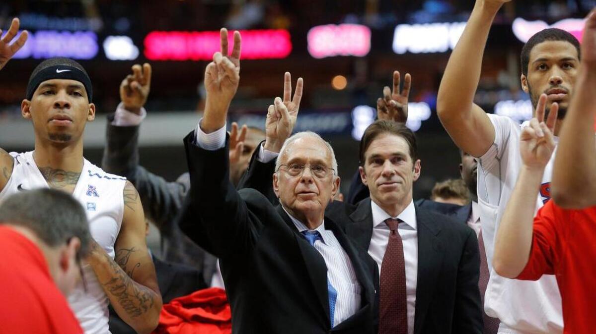 
Southern Methodist Mustangs head basketball coach Larry Brown (center) celebrates with his team after a win. 
