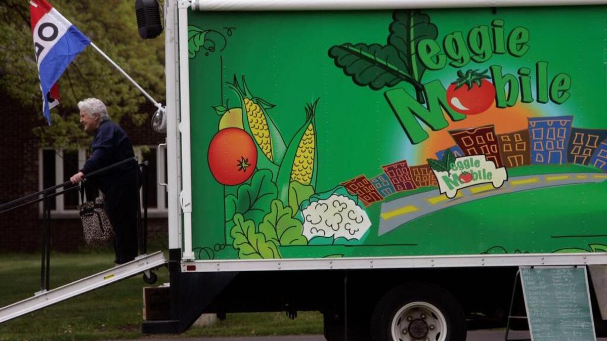 A customer leaves the Veggie Mobile after buying produce in Albany, N.Y., Friday, May 9, 2008. With the rapidly climbing cost of food and fuel, states and nonprofit groups are finding ways to get healthy food to underserved areas.