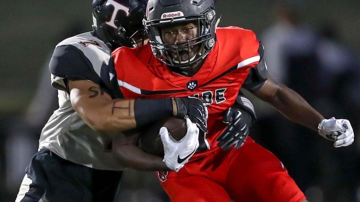 Trinity’s Samuela Kautai tackles Ke’von Ahmad of Colleyville Heritage in Friday’s game at Mustang-Panthers Stadium in Grapevine. Trinity won, 35-21.