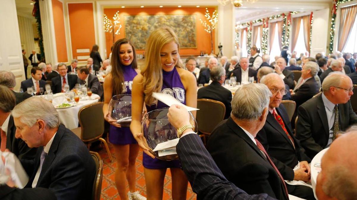TCU cheerleaders Chandler Jordan and Canon Charanza collect Exchange Club donations Dec. 14.