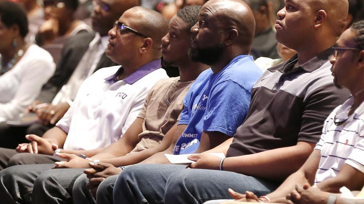 
Adrian Taylor, in blue shirt, Christian Taylor's father, attends a "Unity, Peace and Prayer Rally" at Cornerstone Baptist Church on Wednesday.
