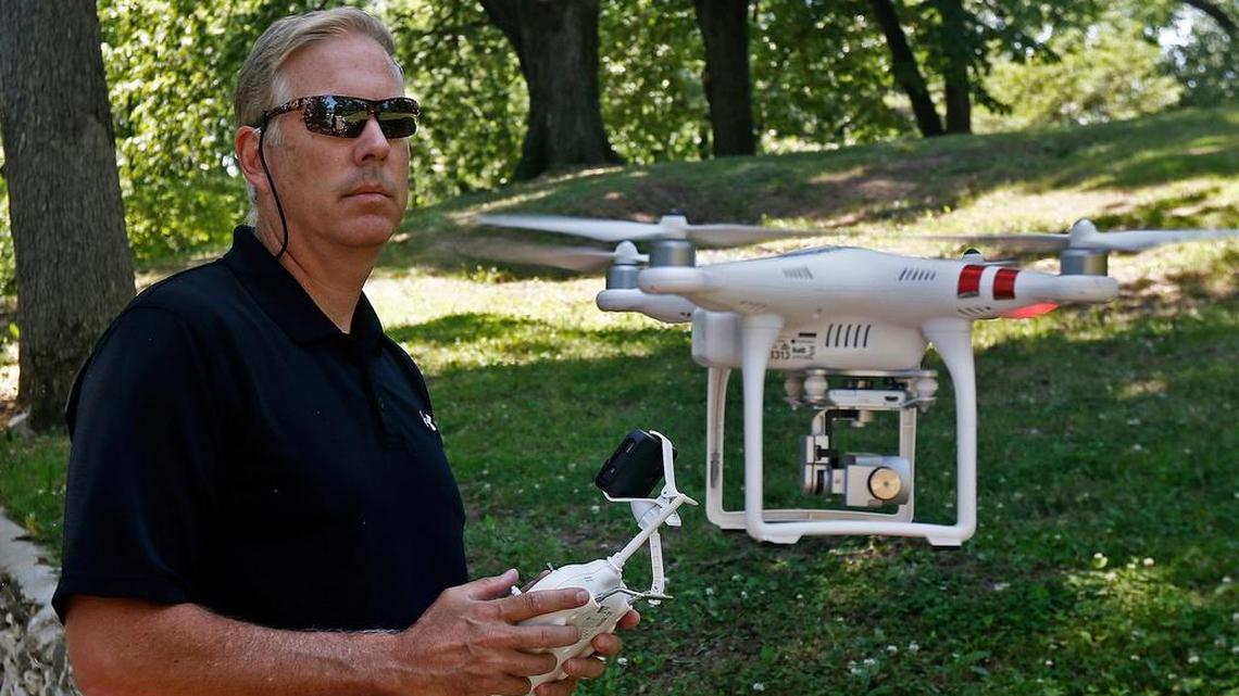 Jim Robesky hovers his DJI Phantom drone at eye level with the remote control, at Parker Heights Park in Quincy, Ill.