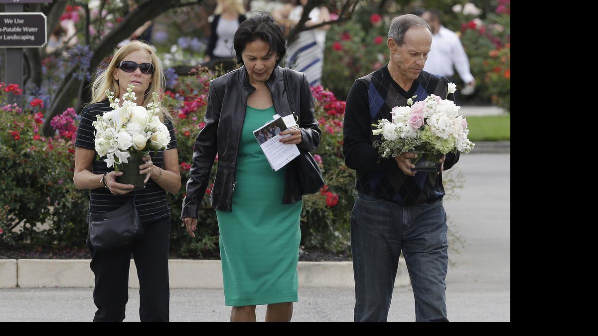 
Two women and a man walk toward the parking lot after a memorial service for Kathryn Steinle in Pleasanton, Calif., on July 9. Steinle, of San Francisco, was gunned down by Juan Francisco Lopez Sanchez on July 1 while walking along a city pier with her father.
