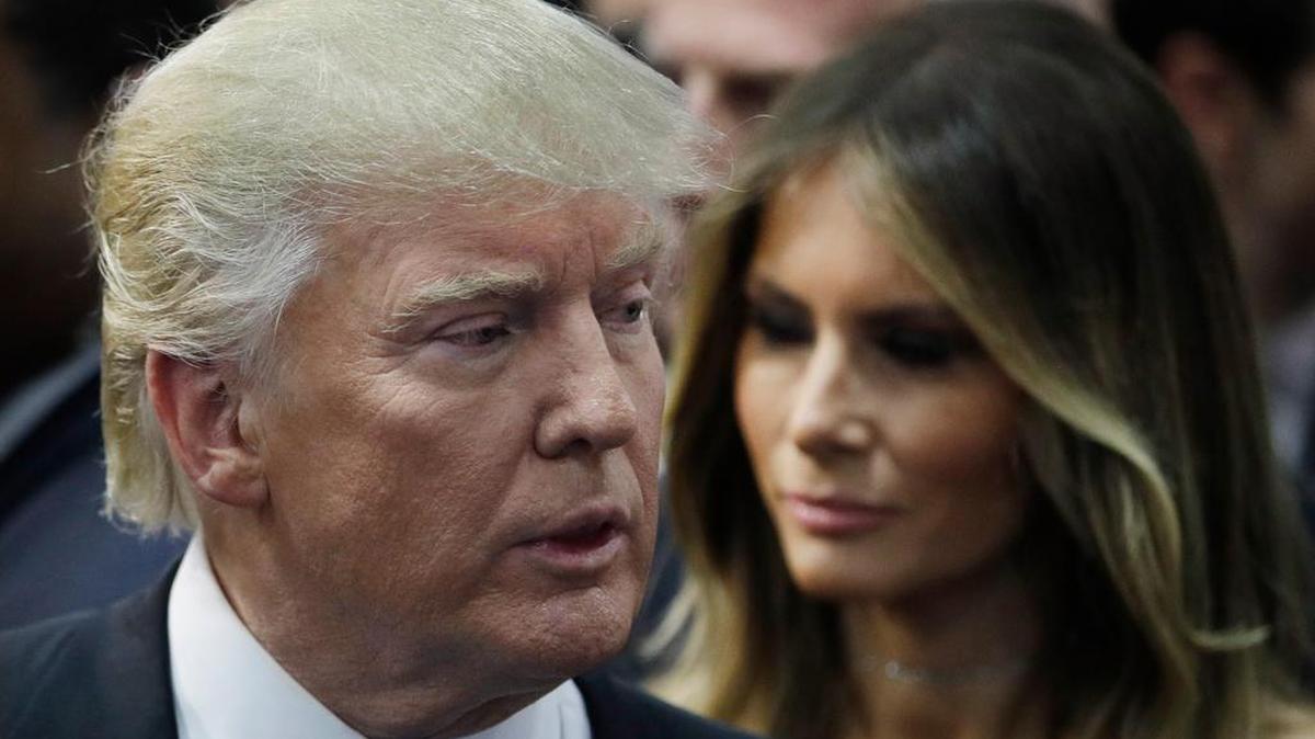 Republican presidential candidate Donald Trump, left, speaks with the media beside wife Melania Trump, right, after Monday’s presidential debate.
