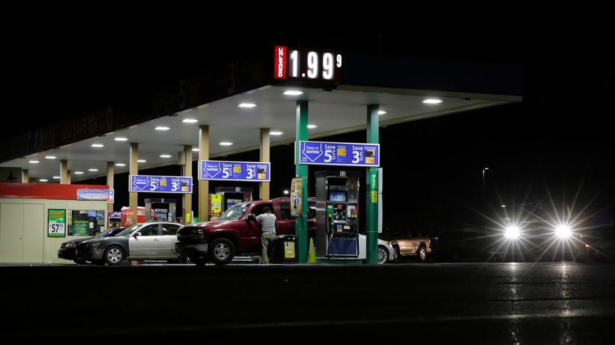 
Motorist purchase gas at a station that dropped the unleaded fuel price to $1.99 per gallon Aug. 26 in San Antonio. 
