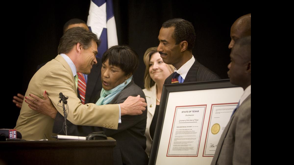 
Gov. Rick Perry hugs the mother of Tim Cole after he signed a pardon for her wrongly convicted son in 2010.
