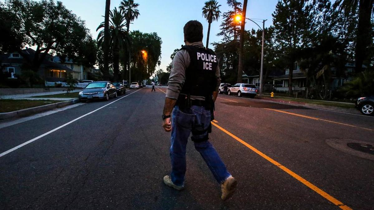 An ICE agent on his way to raid and apprehend an immigrant without legal status.
