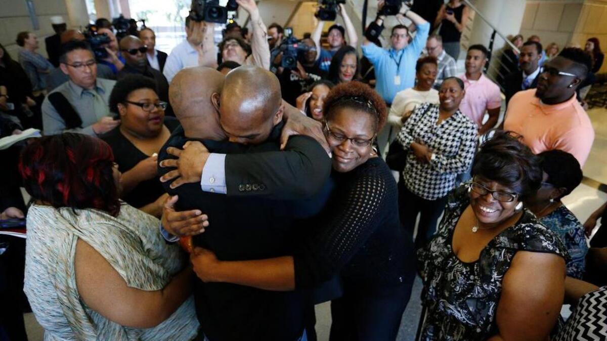 John Nolley (facing camera) hugs his brother LaMarcus Nolley as sister Mia Nolley hugs them on May 17, 2016 in Fort Worth, Texas. John Nolley, from Bedford, was released from custody after 19 years behind bars due to efforts by The Innocence Project. Nolley had been found guilty of murder in 1998.