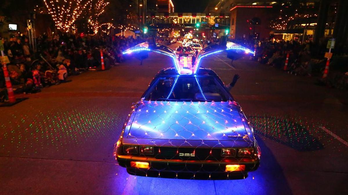A decorated Delorean drives down Commerce Street with its gull-wing doors open at the Parade of Lights in downtown Fort Worth in 2015.