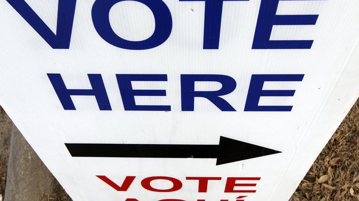 
A sign offers directions to a voting location. 
