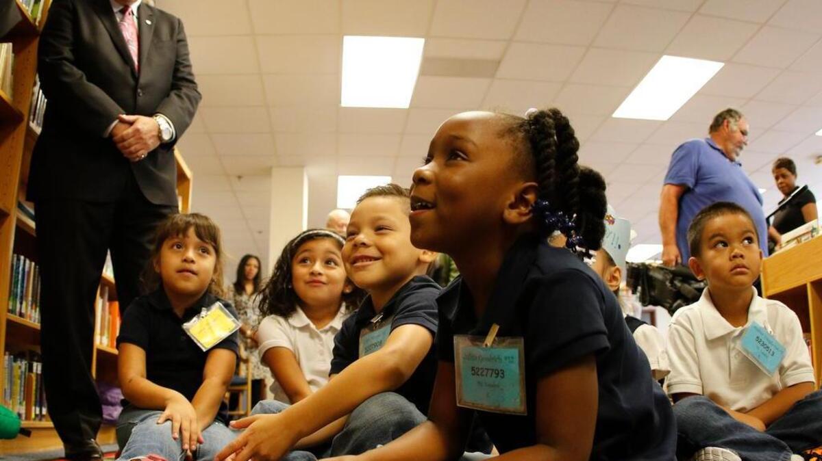 FWISD Superintendent Kent Scribner watches Monday as kindergartners listen to Mayor Betsy Price read.