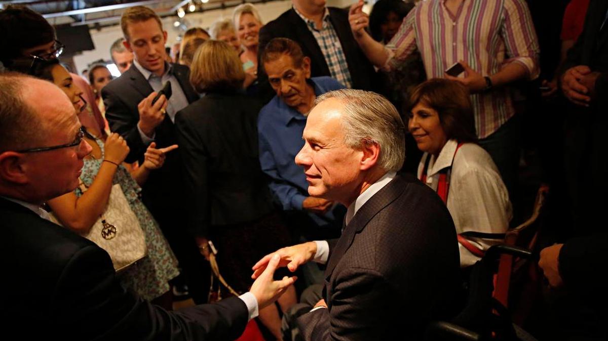 Texas Gov. Greg Abbott (center) meets with supporters in Dallas.
