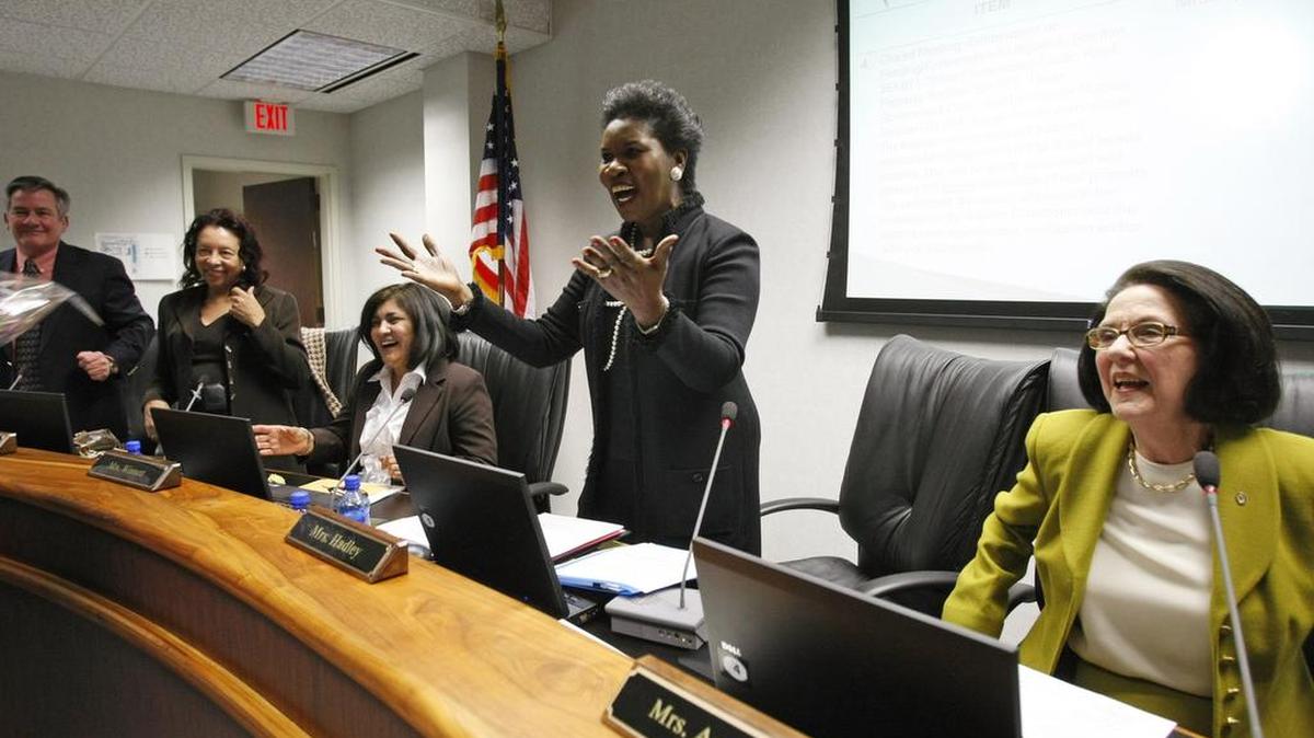 Erma Johnson Hadley prepares to receive flowers from her daughter after she is named the new chancellor of the Tarrant County College system by the TCC Board at their meeting Thursday, March 11, 2010.