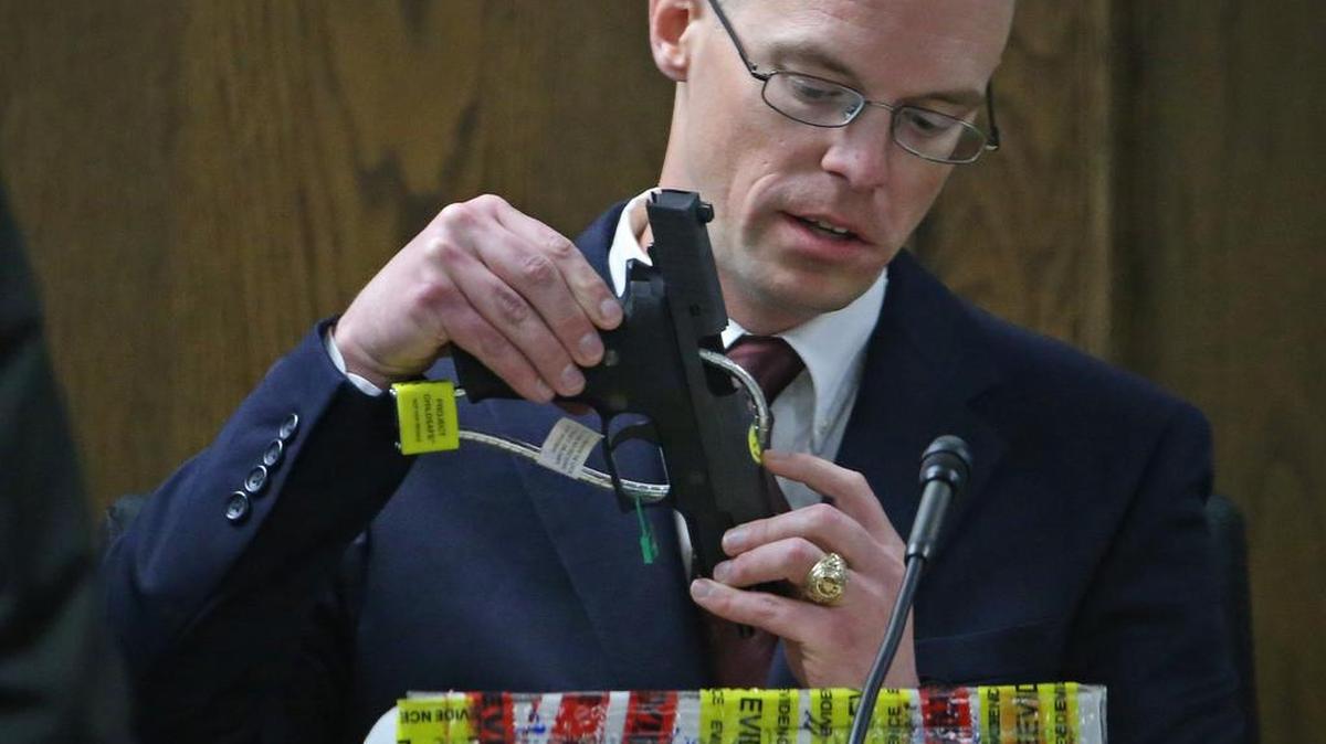 Department of Public Safety forensic scientist James Jeffress examines a pistol during the capital murder trial of Eddie Ray Routh in Erath County in 2015.