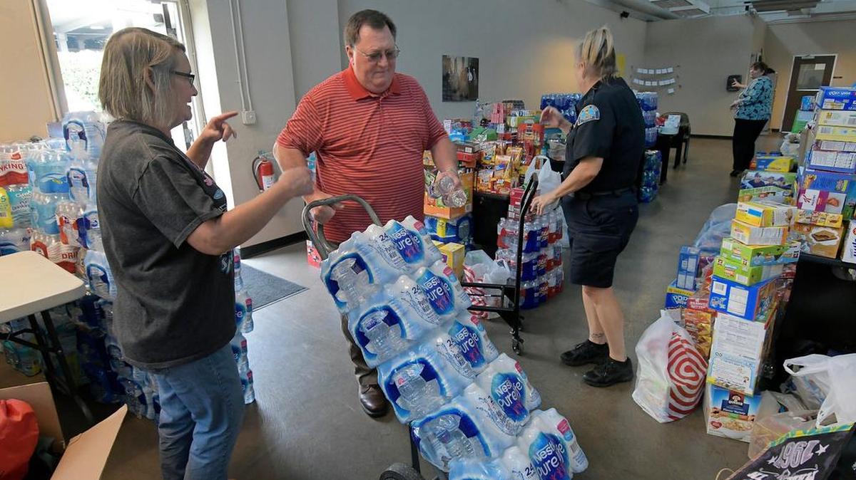 Volunteers and police officers collect water and snacks at the Fort Worth Police Jones Street Substation in Fort Worth, TX, Monday, Aug. 28, 2017. The Fort Worth Police Department are sending 100 officers, drinking water, and snacks to Houston to help to Harvey victims.