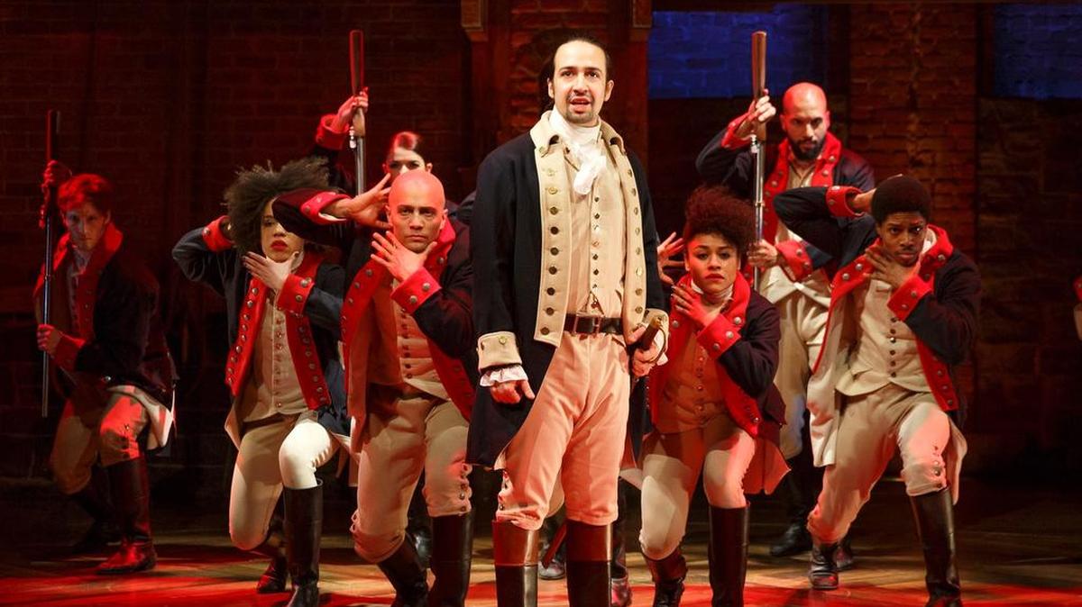 This image released by The Public Theater shows Lin-Manuel Miranda, foreground, with the cast during a performance of "Hamilton," in New York.