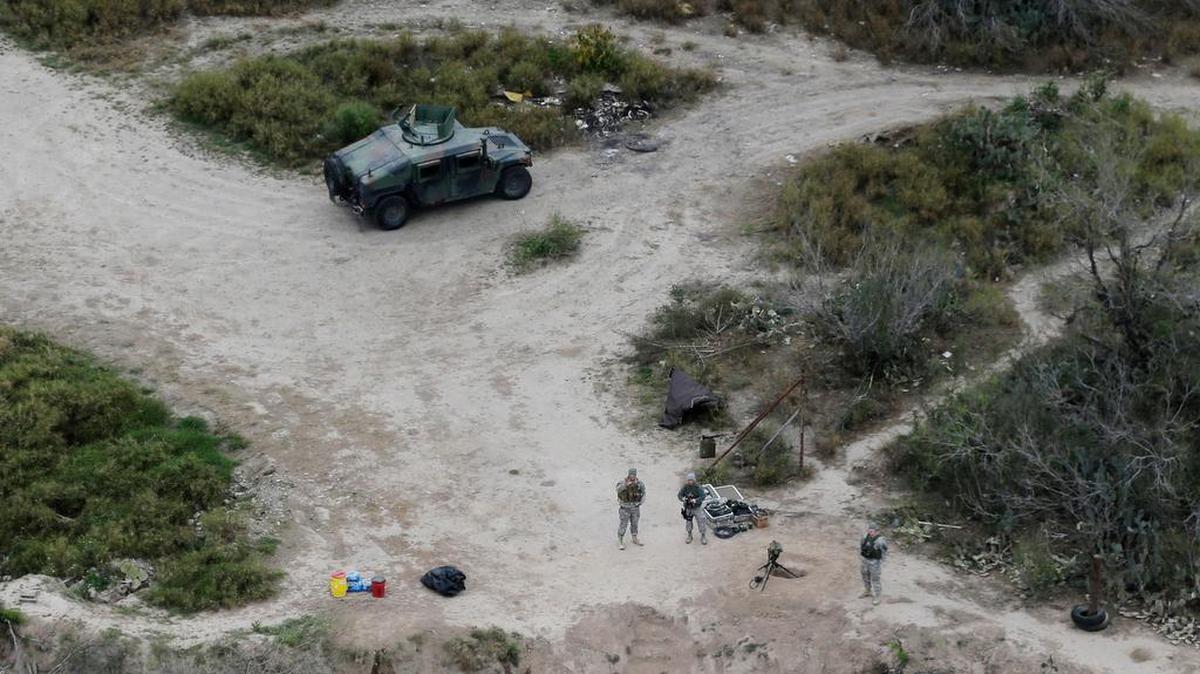 Members of the National Guard patrol along the Rio Grande at the Texas-Mexico border.