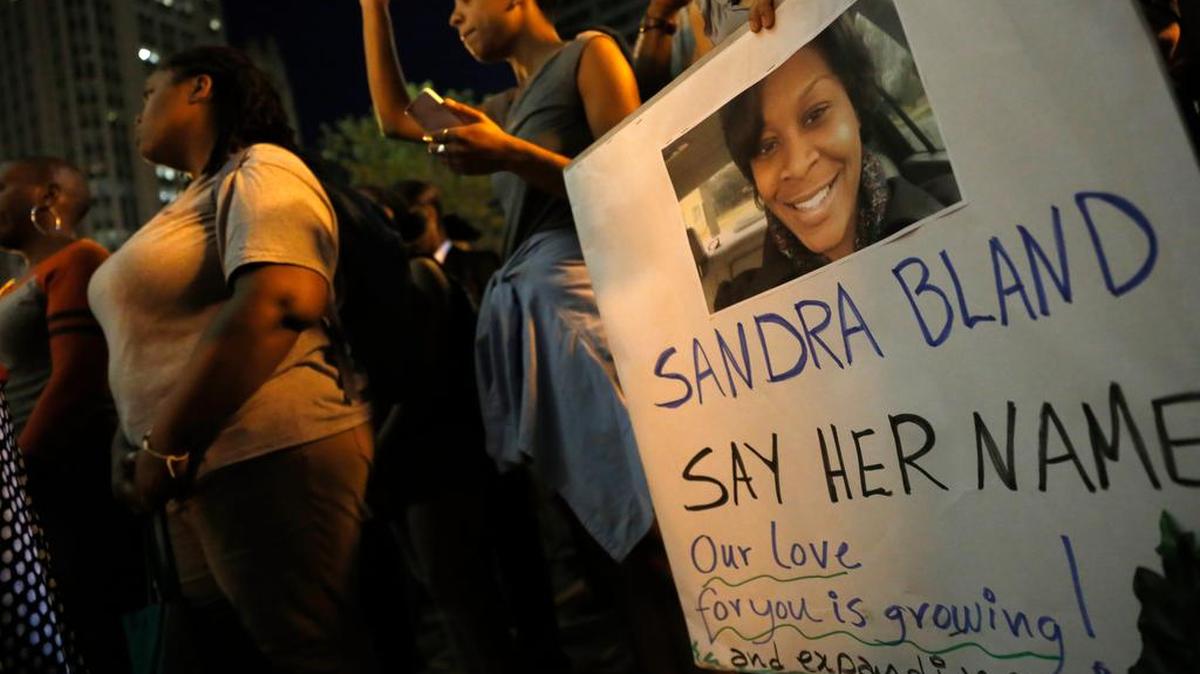 A demonstrator in Chicago holds a Sandra Bland sign during a vigil in 2015.