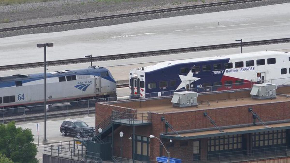 A TRE commuter train passes an Amtrak train on its way into the Intermodal Transportation Center in downtown Fort Worth Tuesday, May 31, 2016. The TRE board is considering expanding service as early as October 2016.