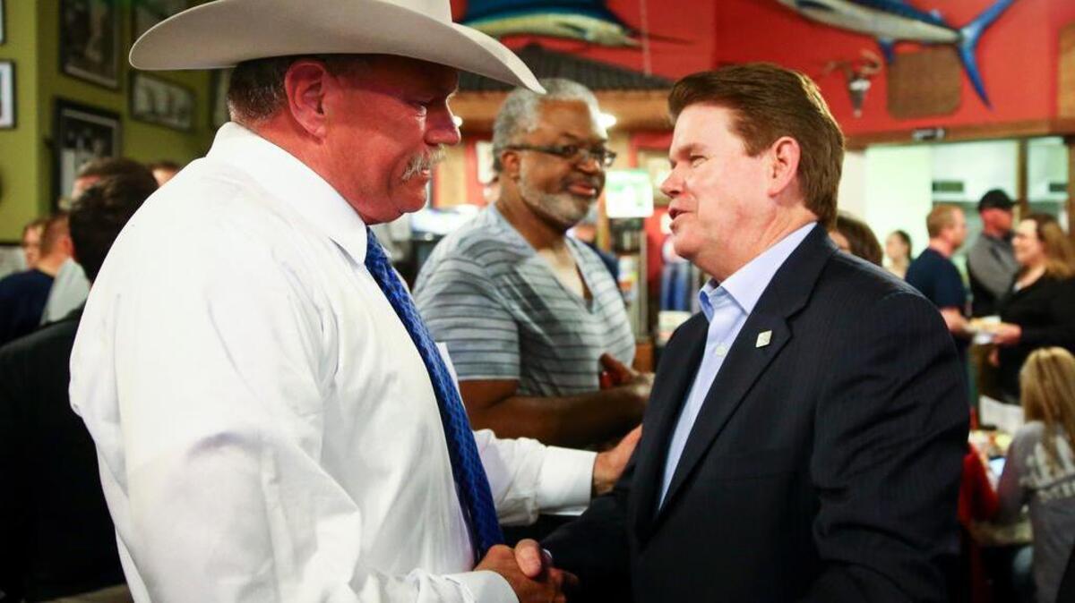 Tarrant County sheriff nominee Bill Waybourn greets Arlington Mayor Jeff Williams.
