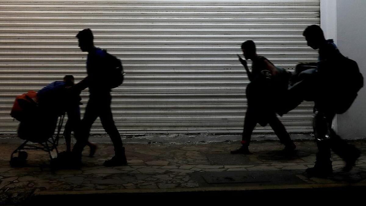 Migrant families camped in a park leave in the middle of the night as they are pushed out by Mexican immigration authorities, in Tapachula, Mexico, early Wednesday, May 29, 2019.